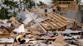 Storm-battered South is again under threat. A boy swept into a drain fights for his life