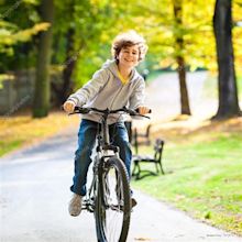 A Boy Riding A Bicycle - bicyklez