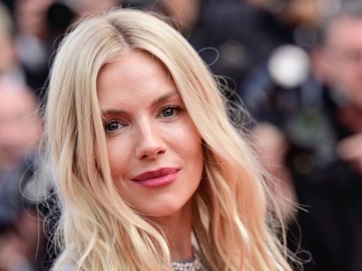 Sienna Miller is a boho vision in white detailed lace top and tiny shorts