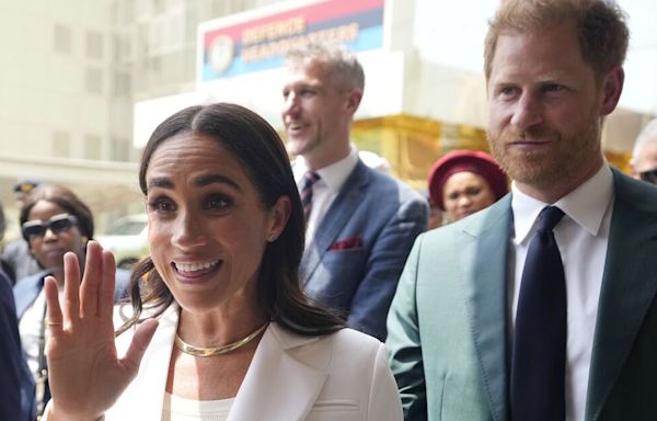 Meghan changes into chic white suit as she and Harry visit army wives in Nigeria