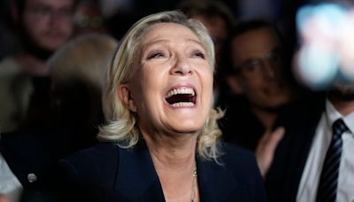 French far-right leader Marine Le Pen swarmed by supporters after lead in first round of election