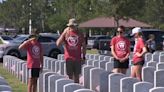 Hundreds of people lay tokens, wreaths for fallen service members at Jacksonville National Cemetery