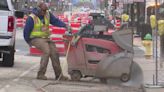 Sidewalk work continues along Adams Street