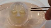 Say cheese: Japanese scientists make robot face 'smile' with living skin