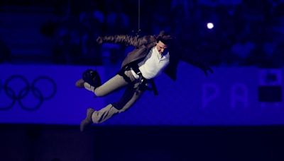 Tom Cruise abseils off stadium roof in daring Olympic finale