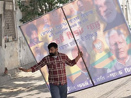 Civic body officials pull down poll campaign hoardings