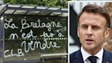 Macron humiliated in D-Day town as memorial flags stolen and graffiti sprayed