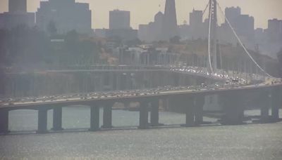 Man jumps into Bay Bridge after vehicle overturns, coast guard rescues him