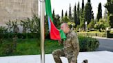 Azerbaijan's president raises the nation's flag in a former breakaway region's capital