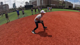 Young baseball players learning from the National Champion University of Tampa Spartans