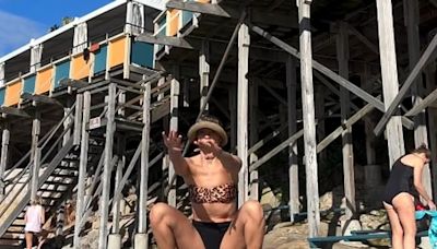 Rachael Finch does squats and push-ups in a bikini at a public pool