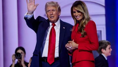 Melania surprises Trump on stage after speech in rare show of affection