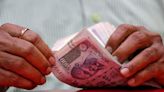 Rupee edges lower tracking fall in Asian peers, forward premiums recede