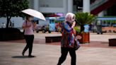 Heatwaves in dozens of Chinese cities buckle roads, pop roof tiles