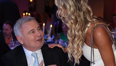 Eamonn Holmes seen in wheelchair as he holds hands with Christine McGuinness at TRIC Awards