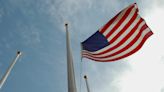 Why are flags being lowered to half-staff in Kansas?