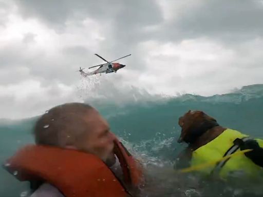 Dramatic video shows US Coast Guard rescue a man and his dog after their boat started sinking during Hurricane Helene