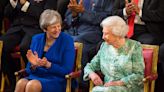 Theresa May Recalls Hilarious Moment She Realized the Queen Saw Her Pick Cheese Up Off the Floor