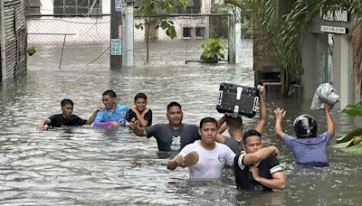 A typhoon kills 3 as it nears Taiwan. It killed 13 in the Philippines, where people plead for rescue