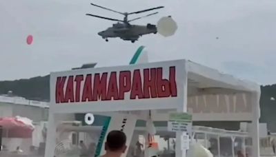 Moment Russian helicopters fly over packed beach sending tourists fleeing