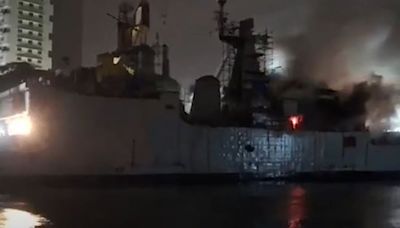 Indian frigate left floating on its side after fire breaks out during repairs