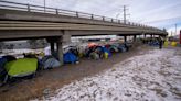 Denver nears its breaking point as migrants and the cold pile in