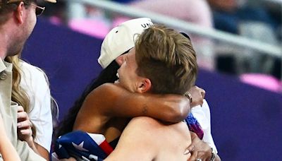 Hunter Woodhall and wife Tara embrace after he wins his first gold medal at the Paralympics