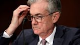 The Dow is hesitating as the Fed announces it may delay rate cuts due to inflation