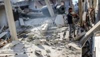 A man stands in the rubble of the house of the sister of Ismail Haniyeh, the Doha-based political bureau chief of the Palestinian Islamist movement Hamas, after it was hit by a strike on June 25, 2024