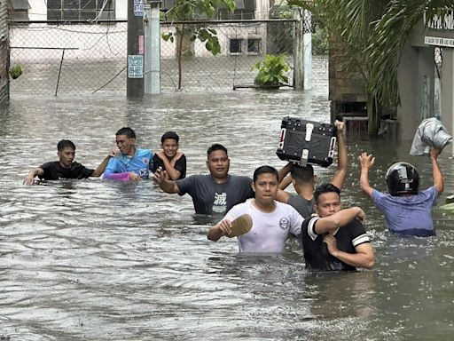 A typhoon kills 3 as it nears Taiwan. It killed 13 in the Philippines, where people plead for rescue