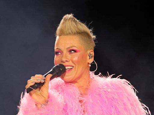 Pink vows to 'kick a**' as she returns to the stage following brief illness