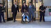 Wheelchair-bound man exits police station after 'dragging dead woman'
