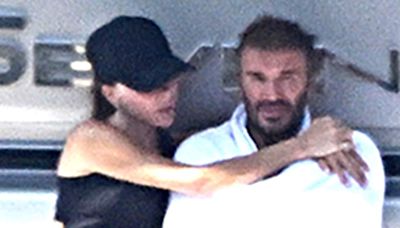 David and Victoria Beckham kiss on their £16million yacht in Italy