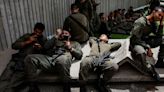 Israeli soldiers tour the 'From Holocaust to Revival Museum' on the day of its reopening after it was damaged by a rocket fired from the Gaza Strip, at Kibbutz Yad Mordechai