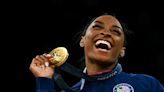 Beaming Biles bags Olympic gymnastics triple, as women's 100m final looms