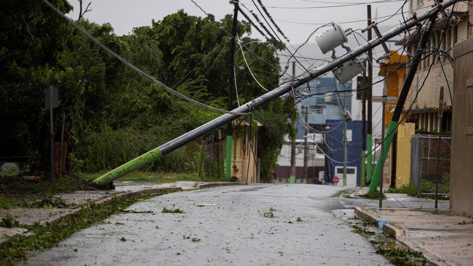 Ernesto strengthens into a hurricane as it knocks out power to nearly half of Puerto Rico