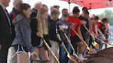 Students break ground on new Monroe high school following years of planning, debate