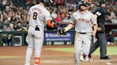 ...San Francisco Giants high fives Michael Conforto after scoring a run against the Arizona Diamondbacks during the fourth inning of the MLB game at Chase Field on June 03...