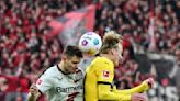 Stanisic rescues Leverkusen in Dortmund as unbeaten run reaches 45