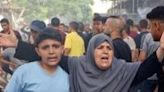 A woman reacts as people search for survivors after Israeli bombardment at Bureij refugee camp, central Gaza