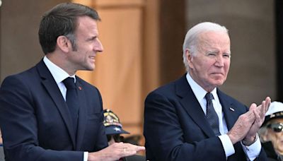 Shocking moment doddering Joe Biden helped by Emmanuel Macron at D-Day parade