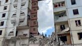 Apartment building partially collapses in a Russian border city after shelling. At least 13 killed