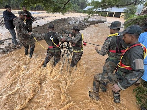 At least 63 dead and hundreds feared trapped in landslides in southern India