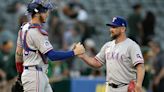 Rangers outslug A's to earn doubleheader split