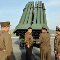 North Korean leader Kim Jong Un inspects the 240mm multiple rocket launcher system at an undisclosed location