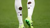 Why do England football players cut holes in their socks?