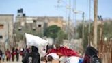 Displaced Palestinians in Rafah, the southern Gaza Strip, carry their belongings following an evacuation order by the Israeli army