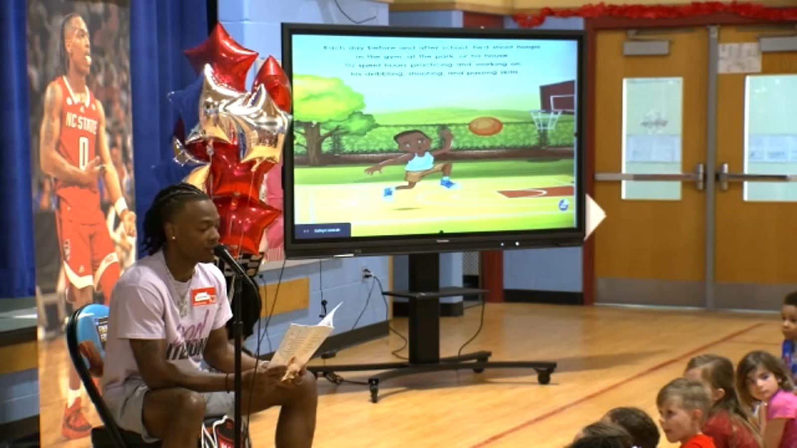 NC State's DJ Horne reads his children's book to Wake County students