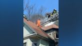 Firefighter rescued from burning roof of Dorchester home, 2 others injured