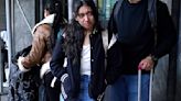 A migrant family leaves the Row Hotel in Midtown Manhattan on Jan.10, 2024. New York City is starting the process of evicting migrant families from city-run shelters if they've been living there for more than 60 days.